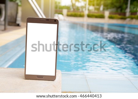 mobile phone with blurred pool in condominium background