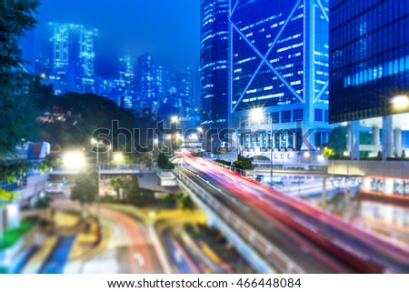 blurred traffic in downtown district,hong kong,china.Chinese characters on road are all traffic roadmarking.
