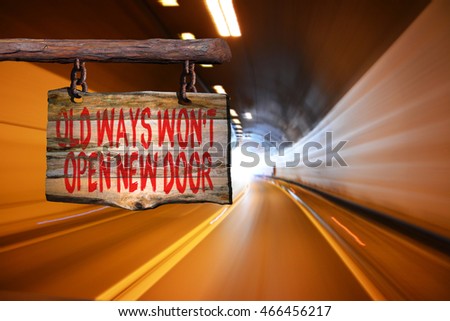 Old ways won't open new door motivational phrase sign on old wood with blurred background