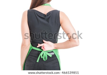 Woman employee with finger crossed behind her back as fake lying concept isolated on white