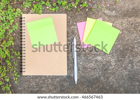 Soft focus image of a notebook with the old cement floor in the morning sun shades.