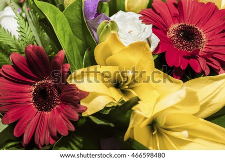 Yellow lilies and red Daisies flowers together in a bunch of  gifts in a fancy gift shop