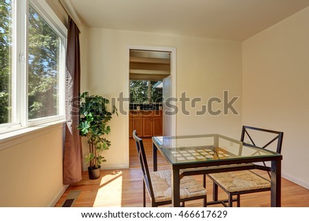 Dining wicker chairs with glass table by the window. Northwest, USA