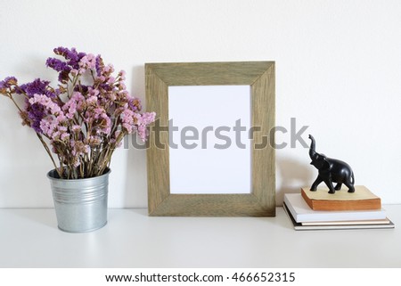 mock up  photo frame with book and flower.  home decoration
