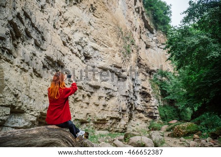 Women photographer traveling in the mountains . 