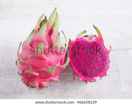 Sliced purple dragon fruits on wooden background
