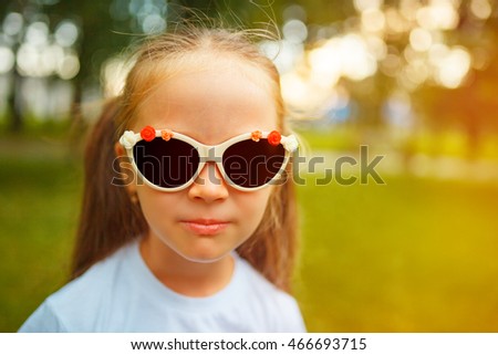 Eyewear, shopping & discount concept. Portrait of funny and sweet little girl. Long brown hair in. Close up.