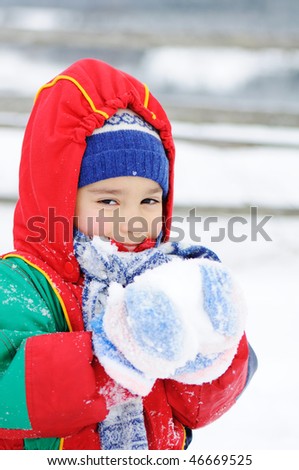 Child in snow, eating
