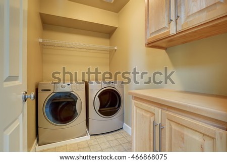 Beige laundry with modern appliances and tile floor. Northwest, USA