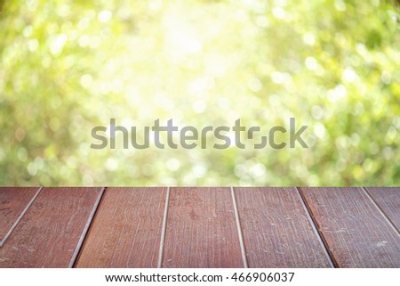 wooden table with space for your photo montage and green color of background