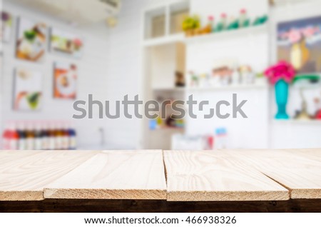 Selected focus empty brown wooden table and Coffee shop blur background with bokeh image. for your photomontage or product display