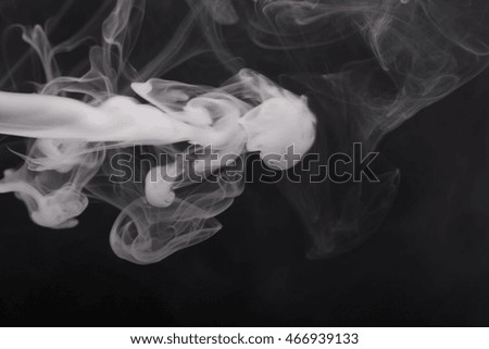 Cloud of smoke on black background. Selective focus.