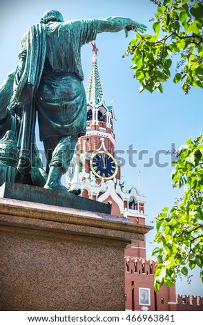Kremlin clock chimes can be seen through the monument to Minin and Pozharsky in Moscow, St. Basil Cathedral. Red Square. vignetting as an artistic effect
