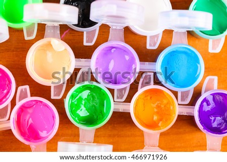 set of colorful paints close-up on wooden background