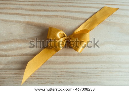 Ribbon Bow on wood background