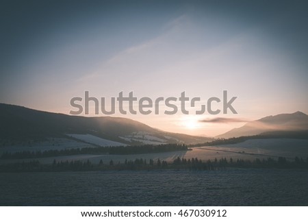 Beautiful sunrise over the countryside in winter - vintage film effect