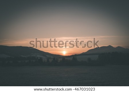Beautiful sunrise over the countryside in winter - vintage film effect