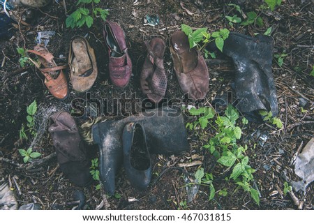 old shoes in the dumpster in forest - vintage film effect