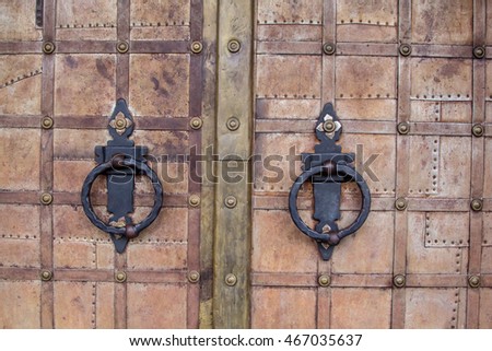 Heavy iron door studded with loops