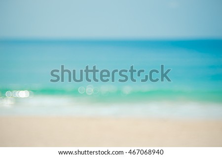 Blur tropical beach with bokeh sun light wave abstract background. Copy space of travel concept. Vintage tone filter color style.