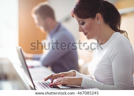 Mature student using laptop in the classroom