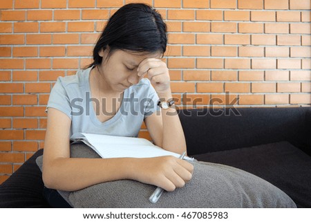 Asian young girl drawing cartoons concept with pencil in book. Little girl writing art creativity. Portrait of children happy.