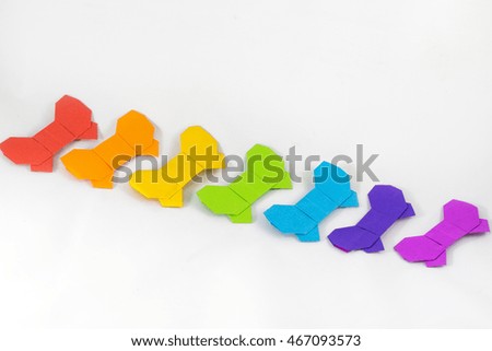 color origami paper bow on white background
