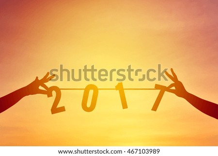 Silhouette hand holding word 2017 concept new year