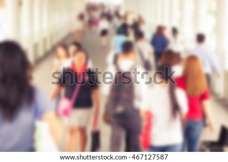 Abstract blurry background of many people walking on skywalk in the big city with vintage color style.