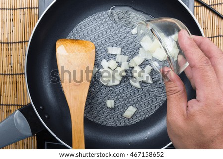 chef putting onion to pan / cooking fried rice concept