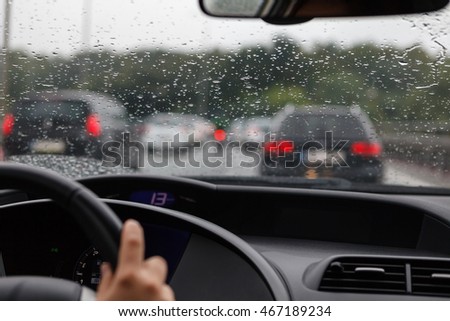 Driving a car in traffic jam in bad weather conditions Royalty-Free Stock Photo #467189234