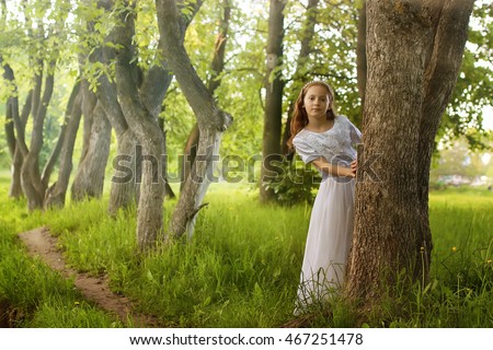girl in fairy tale park with tree in spring