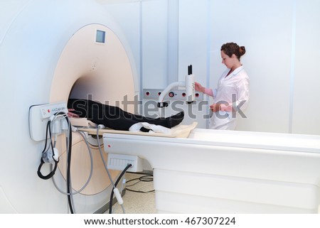 computerized axial tomography scanner in hospital with patient and doctor