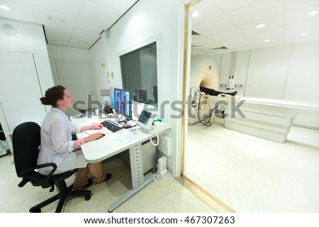 doctor in control room, and magnetic resonance imaging machine with patient