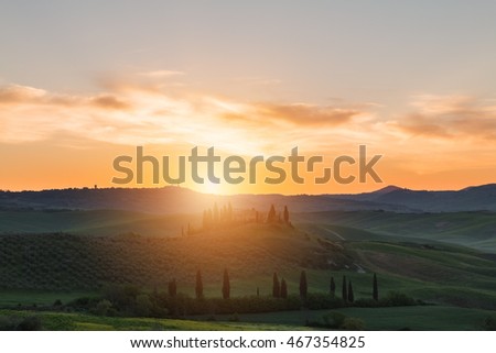 Farmhouse, green hills,cypress trees in Tuscany at sunset in Italy,Europe