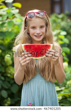 Portrait of a young blonde little girl with watermelon, summer outdoor