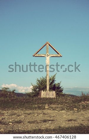 Sign of faith. Wooden cross in a cloudy sky. Mount Kobila, Transcarpathia