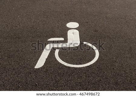 Road sign on asphalt disabled parking spaces