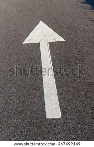 White arrow on asphalt