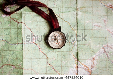 wanderlust and explore concept, compass on map, top view, vintage toned image, space for text