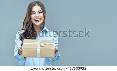 Business woman holding paper gift box. Toothy smiling face. Isolated background.