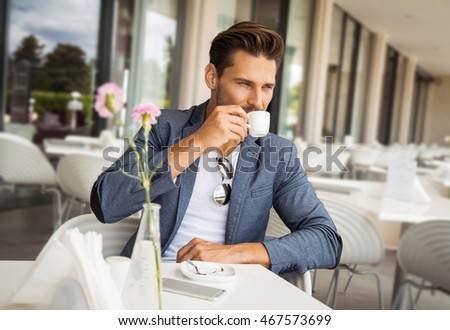 Portrait of handsome man drinking coffee
