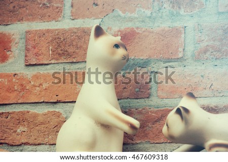 Vintage Plush cat on Brick wall background
