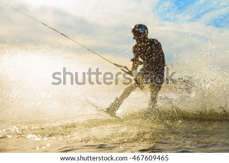 wakeboarder trains at sunset Royalty-Free Stock Photo #467609465