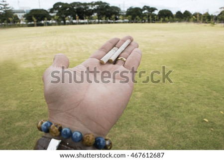cigarette on hand with natural 