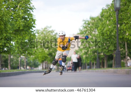 Young man on rollerblades skating at park