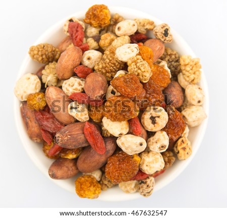 Mix dried super food tiger nuts, mulberry berries, cacao beans, goji berries, golden berry over white background