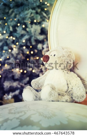 Toy bear against christmas tree background