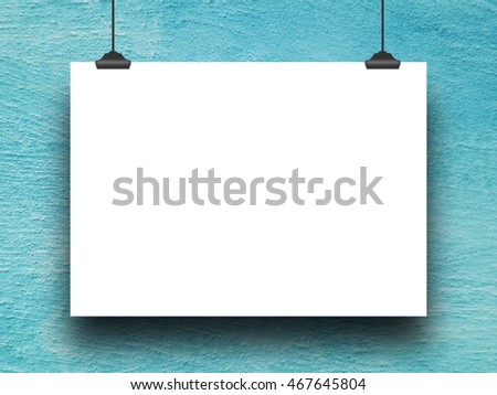 Close-up of one blank poster frame hanged by clips against aqua concrete wall background
