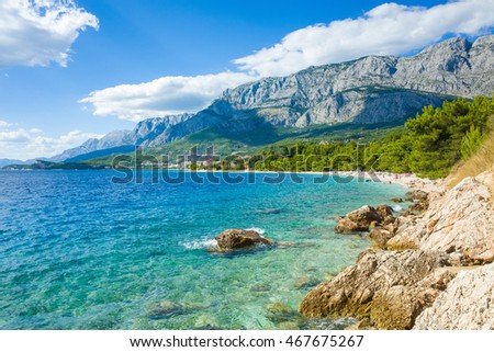 Croatia landscape and coastline. Beautiful Adriatic Sea and mountains in background. Lovely sunny, colorful day with blue sky and white clouds. Hot nice summer afternoon. Joyful and happy picture.